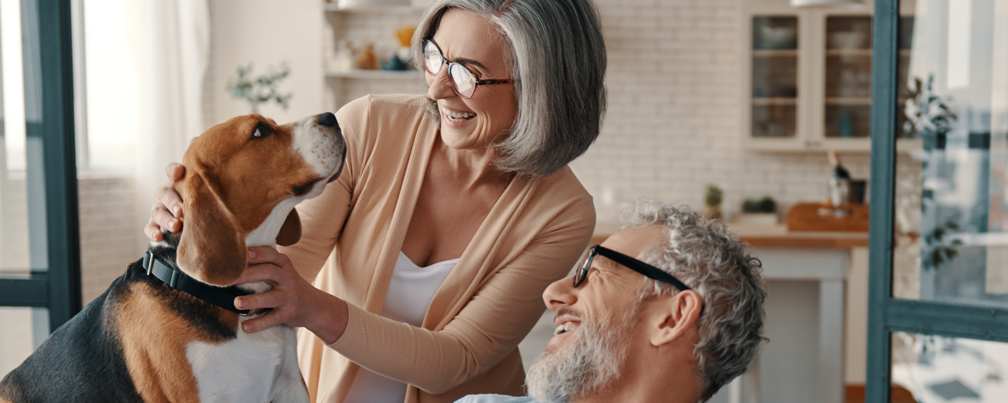 Man and woman with their dog in their living room