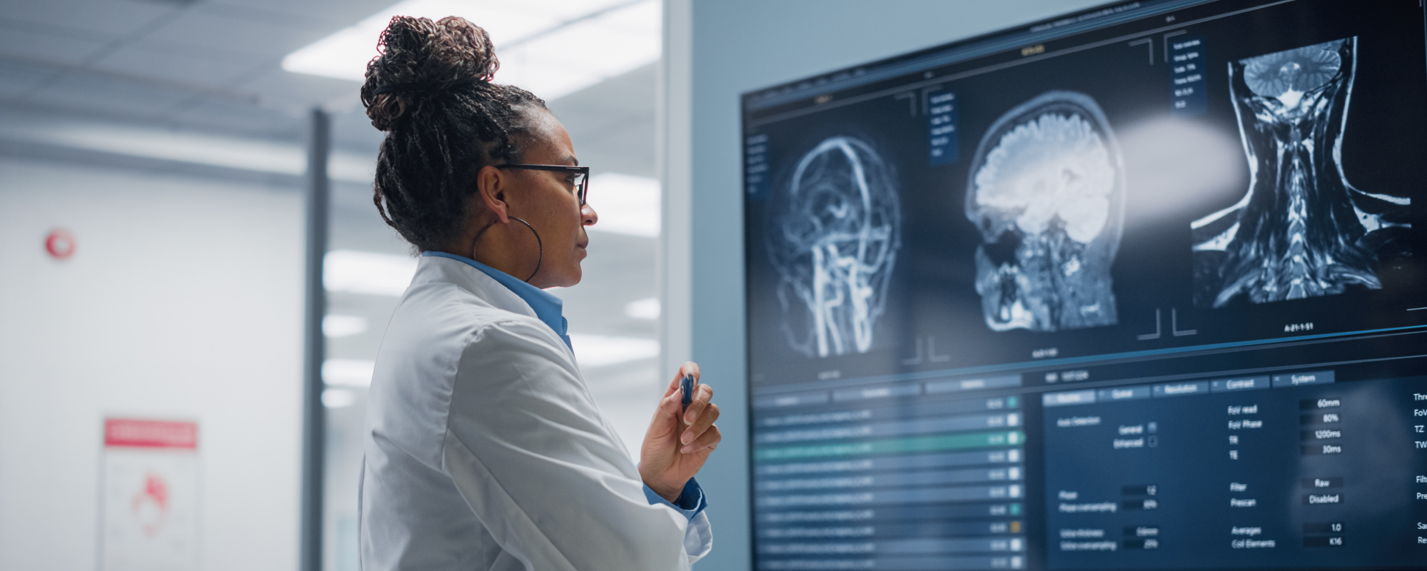 Woman physician looking at a brain scan on a monitor