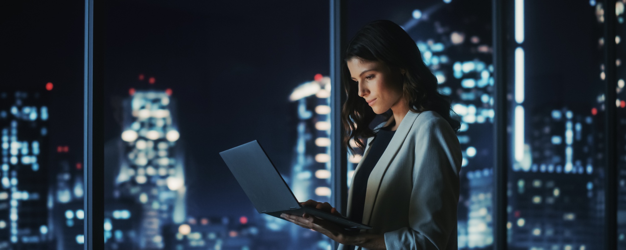 Woman on her laptop in an office at night