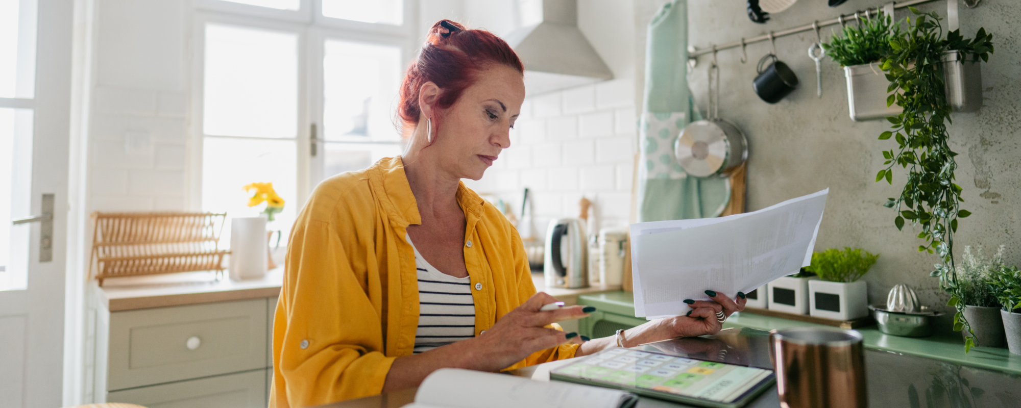 Woman reviewing her tax documents in her kitchen