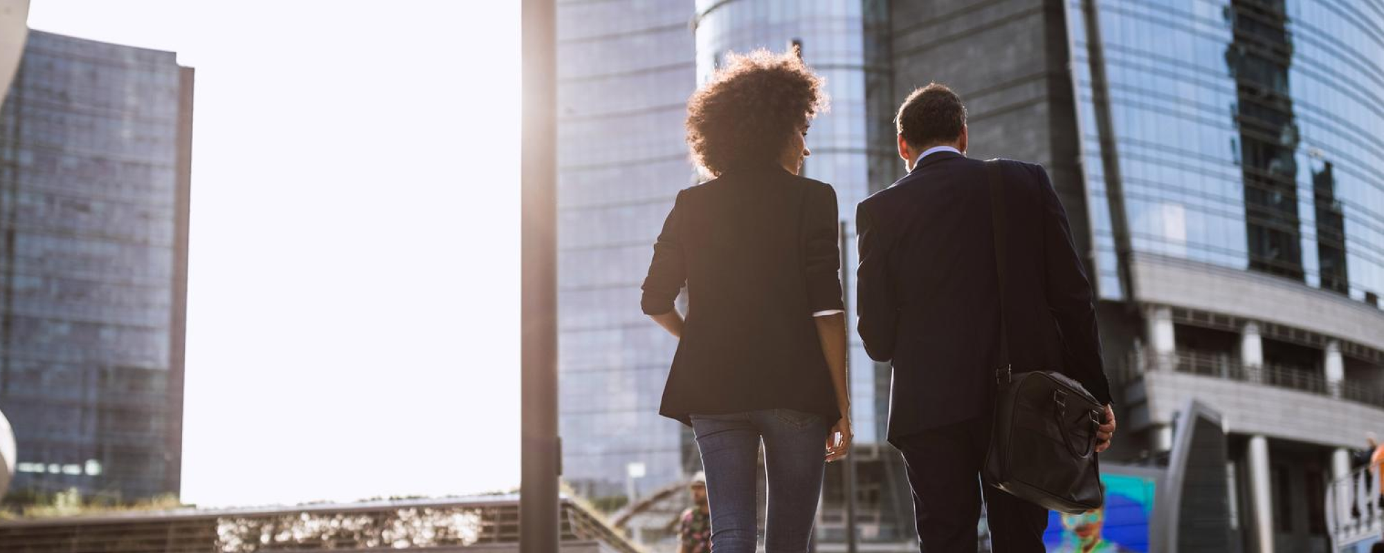 Couple walking in front of office buildings
