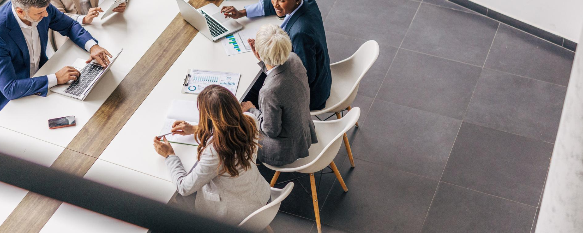people sitting around board room table.