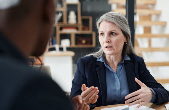 woman in suit speaking to someone