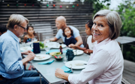 family sitting at a table outside