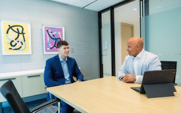 Two men sitting in a boardroom