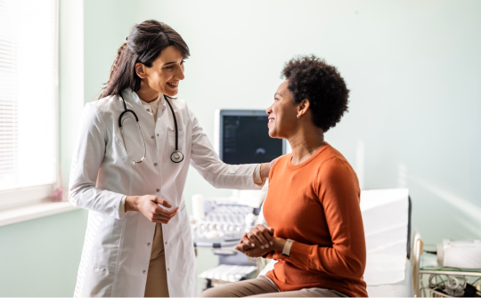 female physician speaks to her patient