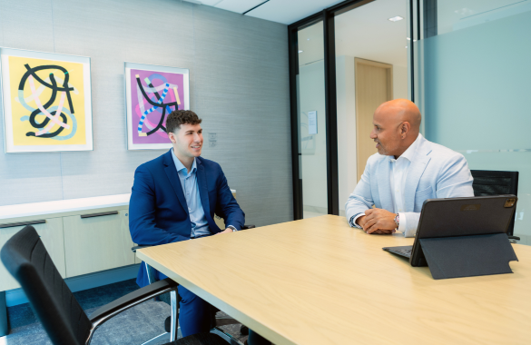 Two men sitting in a boardroom
