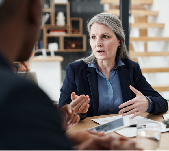 woman in suit speaking to people out of frame