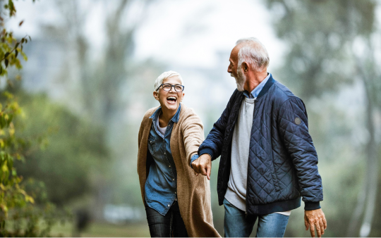 elderly couple hiking in forest