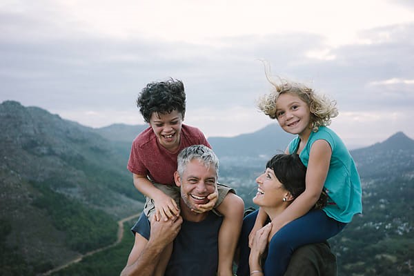 Parents and children together outdoors in the mountains.