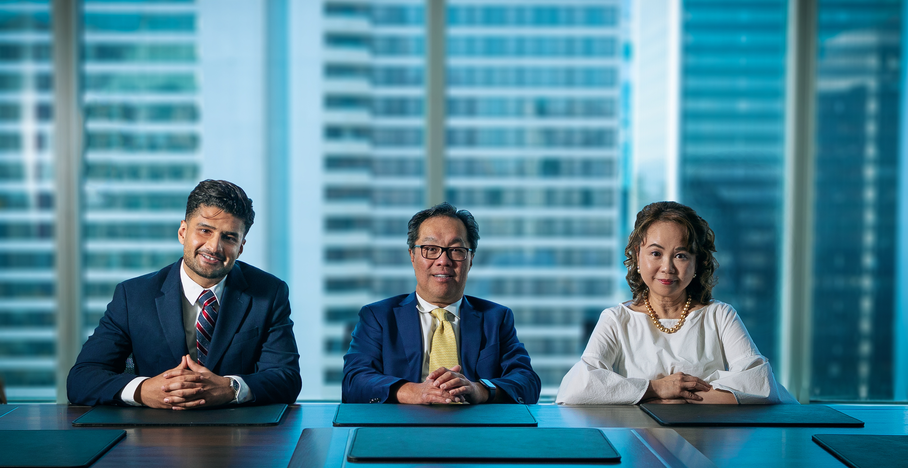 The KMD Group seated at a desk inside an office 