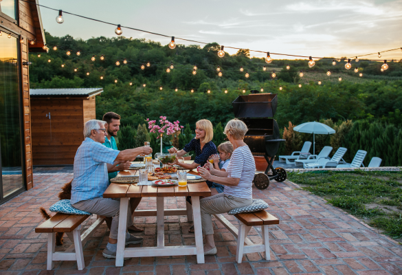 family of five eating a meal at a picnic table