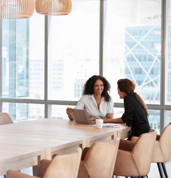 two women sitting in a meeting room