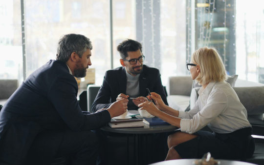three people in a meeting
