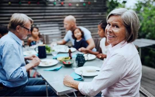 family sitting at picnic table