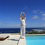 person doing yoga beside a pool