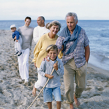 extended family walking on the beach