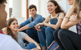 group of young teens sitting and laughing