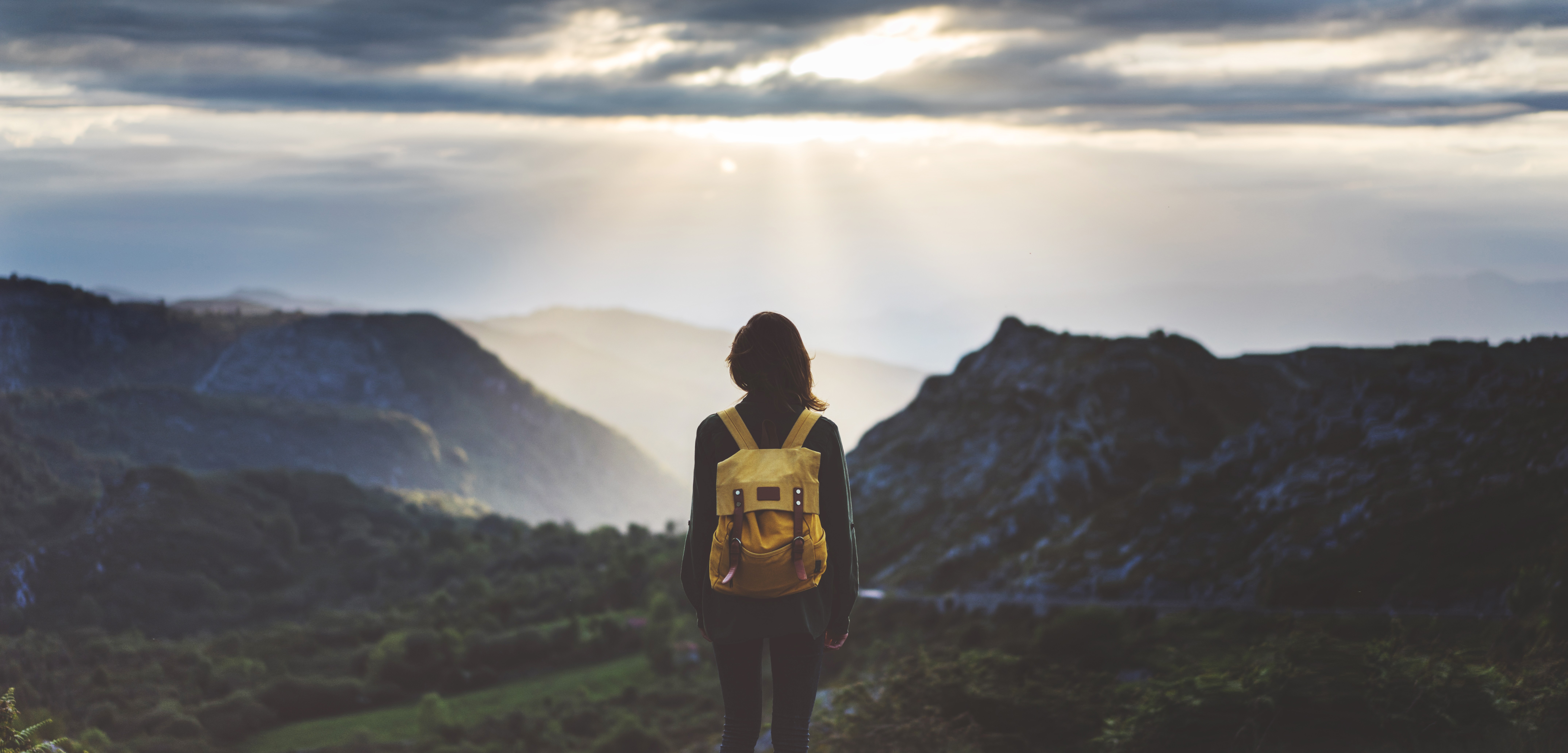 Woman standing overlooking mountaintop