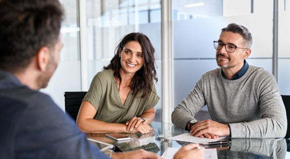 two people talking with a man in a suit