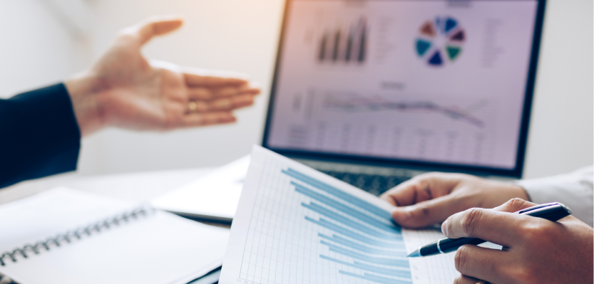 two people talking while looking over charts