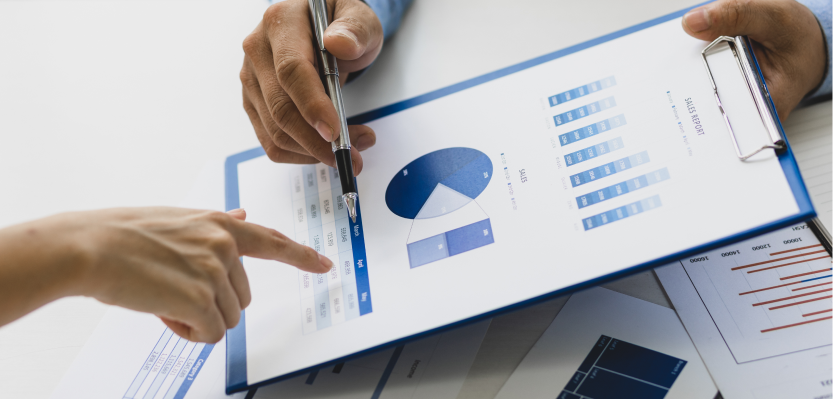 two people looking at clipboard with chart on it