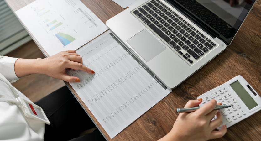 person sitting at laptop doing calculations