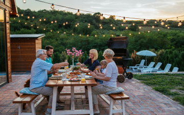 family eating meal at picnic table