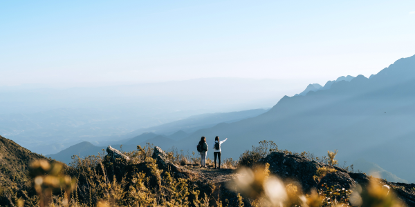 Two people hiking on top of a mountain